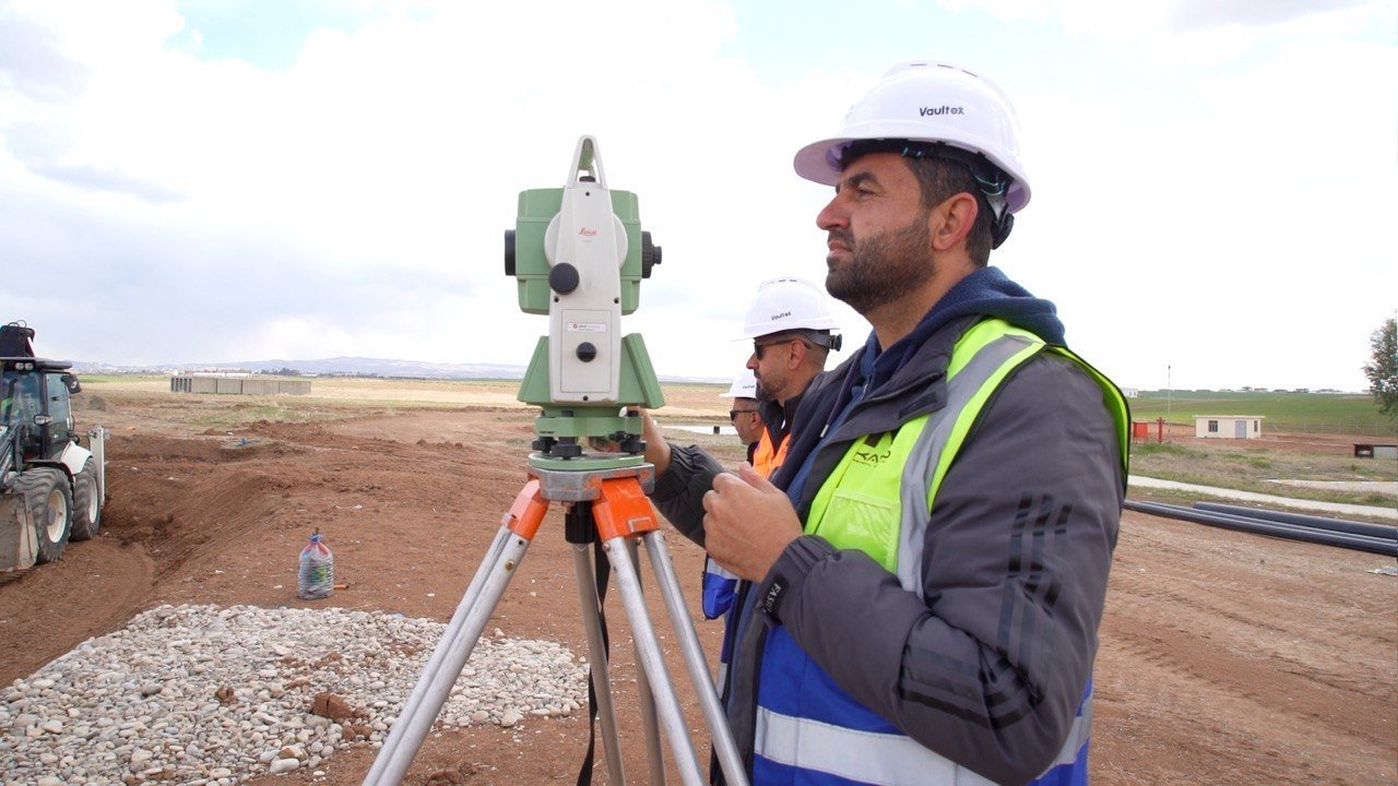 KATO surveyors using a total station at a construction site